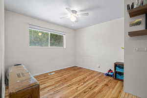 Bedroom featuring light wood-type flooring, a textured ceiling, and ceiling fan