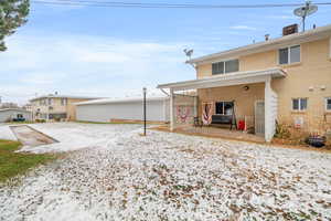 back of property featuring brick siding and a patio area