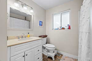 Full bathroom featuring vanity, tub and shower.