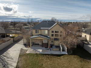 View of front facade featuring a fenced backyard, stone siding, stucco siding, and a patio