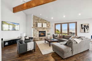 Living area featuring wood-type flooring, a stone fireplace, and recessed lighting
