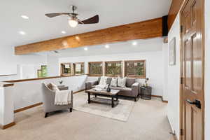 Living room with recessed lighting, light carpet, a ceiling fan, and beamed ceiling