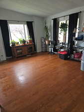 Office area featuring healthy amount of natural light, wood-type flooring, and vaulted ceiling