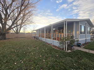 View of property exterior featuring a sunroom