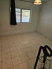 Empty room with light tile patterned floors