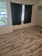 Empty room with wood tiled floors
