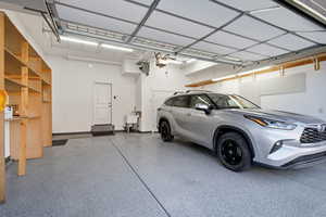 Heated garage with plenty of storage, shelves, sink.
