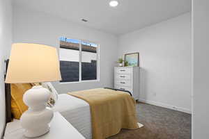 Carpeted bedroom featuring baseboards