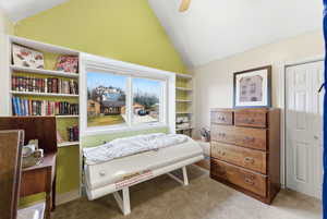 Bedroom featuring light carpet, lofted ceiling, ceiling fan, and a closet