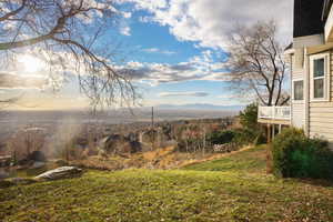 View of grassy yard with a mountain view