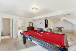 Playroom with billiards, carpet, and a textured ceiling