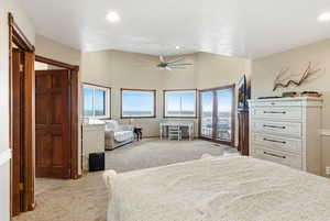 Bedroom featuring light colored carpet, ceiling fan, french doors, and lofted ceiling