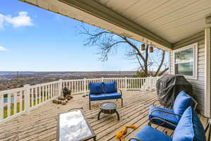 Wooden deck with outdoor lounge area and area for grilling