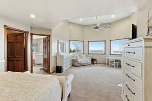 Bedroom featuring ceiling fan, light carpet, high vaulted ceiling, a textured ceiling, and recessed lighting