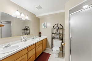 Bathroom featuring double vanity, a shower stall, and light tile patterned floors