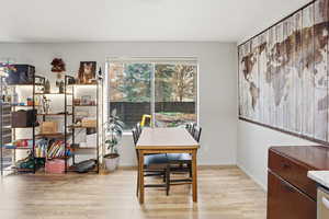 Dining area featuring light wood-type flooring and a desk