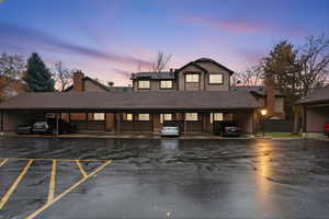 View of front of house with covered parking and roof with shingles