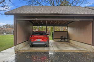 View of parking with an attached carport