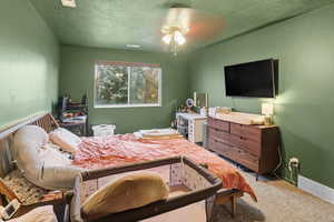 Carpeted bedroom with a textured ceiling
