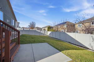 Fenced backyard featuring a patio area and a residential view
