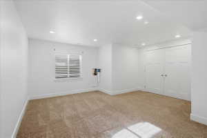 Spare room featuring light colored carpet and recessed lighting