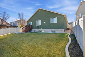 Back of house featuring a fenced backyard, a patio area, and stucco siding