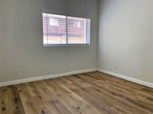 Empty room with wood finished floors and baseboards