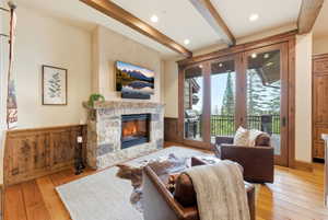 Stone-clad fireplace with a natural wood mantel