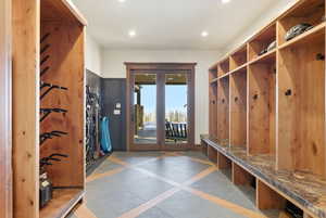 Mudroom with inlaid floor details and recessed lighting