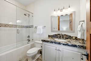 Bathroom featuring vanity and tiled shower / bath