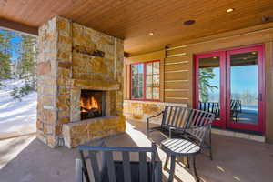 View of patio featuring an outdoor stone fireplace