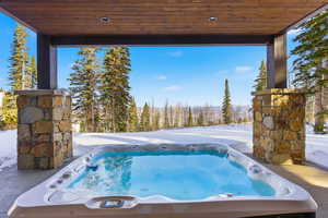 View of pool featuring an outdoor hot tub
