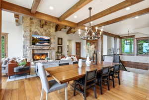 Expansive living area featuring wood-finish flooring and exposed wooden ceiling beams