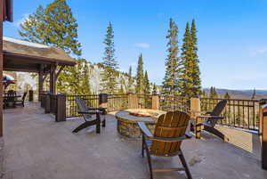 View of patio with a fire pit and a mountain view