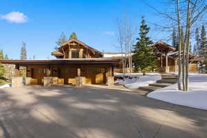 View of front facade with stone siding and a garage