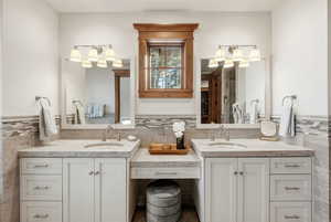Full bath with double vanity and two vanities