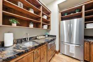 Built-in wood shelving and cabinetry complement the multi-toned countertop