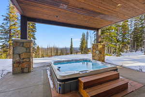 View of patio with a hot tub