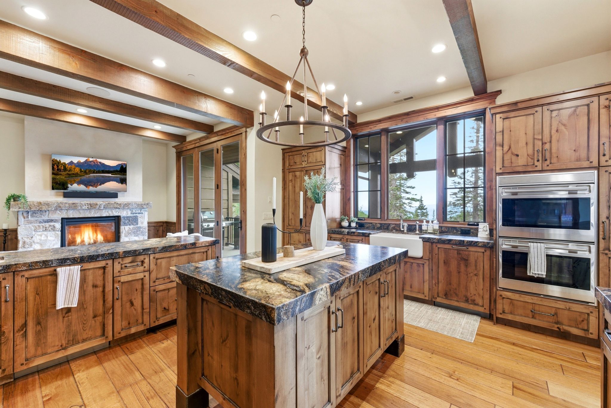 Spacious kitchen featuring wood-finish flooring, exposed ceiling beams, and recessed lighting
