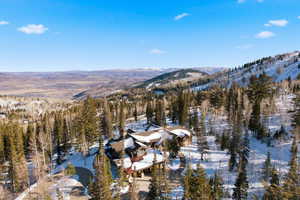 Snowy aerial view featuring a mountain view