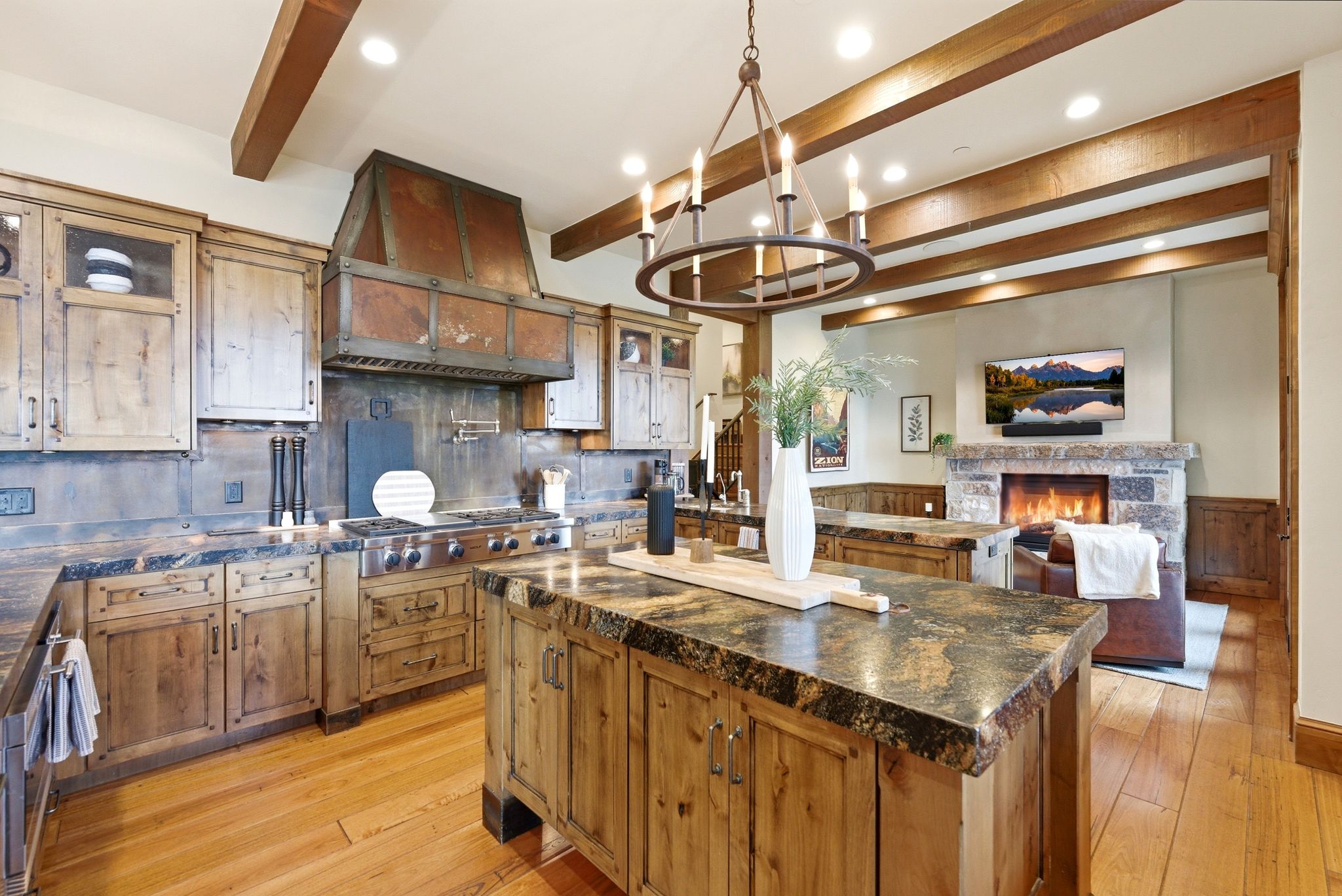 Gourmet kitchen with custom cabinetry, professional-grade range, and a distinctive copper hood