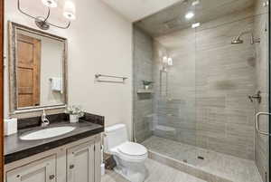 Bathroom featuring vanity and a stall shower