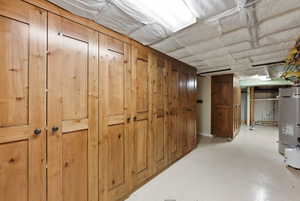 Custom wood-finish cabinetry with dark hardware and a light-toned flooring