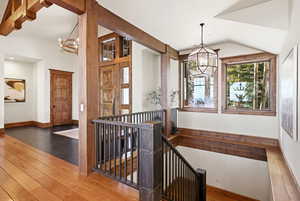 Staircase featuring a chandelier and hardwood / wood-style floors