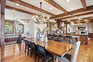 Dining room with a chandelier, recessed lighting, light wood-style flooring, and beam ceiling
