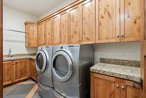 Washroom with cabinet space and washer and dryer
