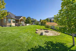 Fenced backyard with a patio, an outdoor fire pit, and a mountain view