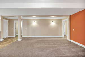 Basement with light carpet and baseboards