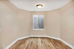 Unfurnished room featuring light wood-style floors and baseboards