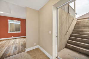 Stairs with baseboards and wood finished floors